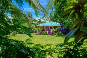una pequeña casa con un techo azul en un patio en Casa Lavanda in tropical jungle garden, en Manzanillo