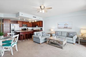 a living room with a couch and a table at Spacious Resort Condo with Breathtaking Gulf Views! by Dolce Vita Getaways PCB in Panama City Beach