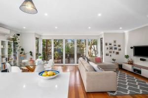 a living room with a couch and a table at Explore Frankston South from this lovely home in Frankston