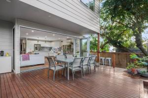 a patio with a table and chairs on a deck at Explore Frankston South from this lovely home in Frankston
