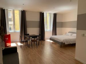 a bedroom with a bed and a table and a desk at Il Tasso Rooms & Apartments in Trieste