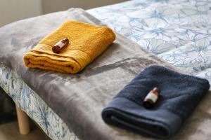a table with two towels and two bottles on it at "Logis Debussy"- Saintes in Saintes