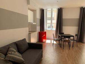 a living room with a couch and a table at Il Tasso Rooms & Apartments in Trieste