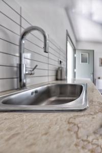 a stainless steel kitchen sink in a kitchen at Little house in the olive grove in Melissátika