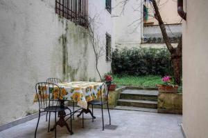 a table and chairs with a table cloth on it at Il Tulipano Apartment With Patio in Florence