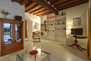 a living room with a table and a television at Il Tulipano Apartment With Patio in Florence