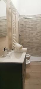 uma casa de banho com 2 WC, 2 lavatórios e um chuveiro em CASA LOSURIELLO em Triggiano