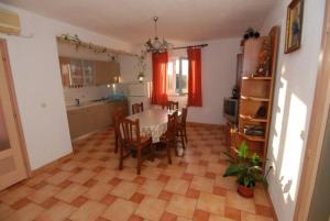 a kitchen and dining room with a table and chairs at Apartments Kraj, Tratica Beach in Kraj +15 photos