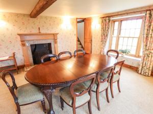 a dining room with a wooden table and chairs at Old Hall Farm in Spilsby