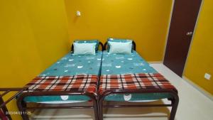 Postelja oz. postelje v sobi nastanitve Homestay An-Nur Residensi Pendang