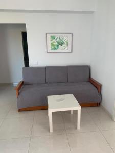 a living room with a couch and a coffee table at Squash Club Apartamentos in Portimão