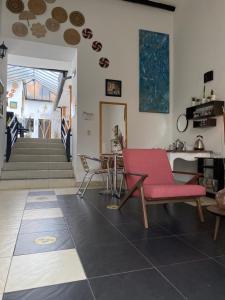 a living room with a red couch and a table at Hotel Alicante in Tunja