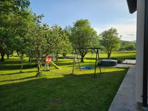 einen Spielplatz mit Schaukel im Hof in der Unterkunft Apartment Topalović in Korenica