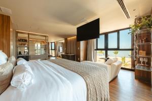 a bedroom with a large white bed and a large window at BA'RA Hotel in João Pessoa +129 photos