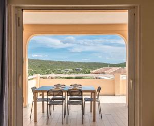 a table and chairs on a balcony with a view at Residence Baia de Bahas Golfo di Marinella in Santa Marinella