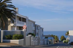 a street with houses on the side of a road at Penguin Paradise Apartment Simons Town in Simonʼs Town