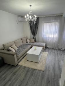 a living room with a couch and a table at Apartman Bajo 1 in Foča