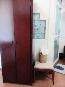 Cette chambre dispose d'une porte en bois et d'un tabouret. dans l'établissement RB studio apartment with free Wi-Fi, à Dar es Salaam