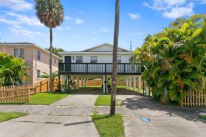 a house with a balcony and palm trees at Boho Inspired Apt in the heart of Tampa Bay! in Tampa