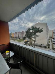 a balcony with a view of a tree on a building at SEASIDE APARTMENT in Liepāja
