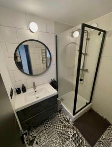a bathroom with a shower and a sink and a mirror at SEASIDE APARTMENT in Liepāja