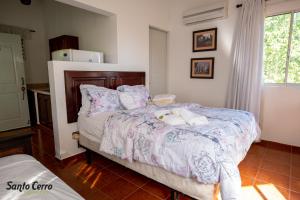 a bedroom with a bed with towels on it at Hotel Santo Cerro Natural Park in Santo Cerro