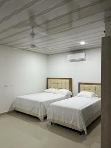 Cama ou camas em um quarto em Hotel Palmeras Del Sinu