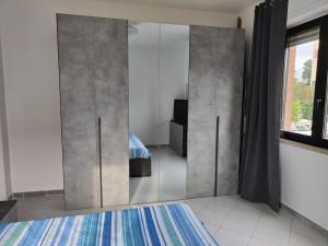 a bedroom with a bed and a large mirror at Casa Trezza 3 in Latina
