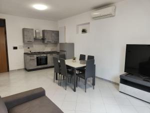 eine Küche und ein Esszimmer mit Tisch und Stühlen in der Unterkunft Casa Trezza 3 in Latina