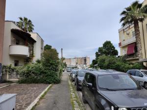 a row of cars parked on the side of a street at Casa Trezza 3 in Latina