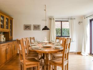 a dining room with a wooden table and chairs at Evergreen House in Runswick