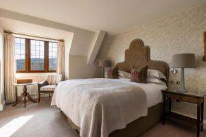 a bedroom with a large bed and a window at Bovey Castle in Moretonhampstead