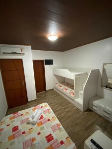 a small room with two bunk beds in it at Kitnet próximo à Praia do Forte in Mata de Sao Joao