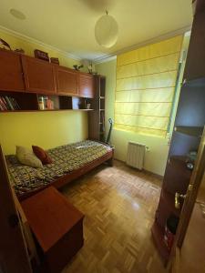 a small room with a bed and a window at Casa Chus in Foz