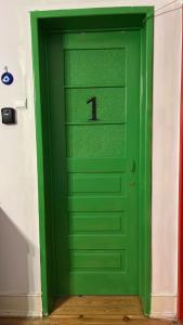 a green door with the number one on it at Rostelbem Guesthouse Lisbon in Lisbon