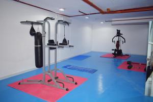 a gym with exercise equipment in a room at Atlantis International Hotel Apartments in Kuwait