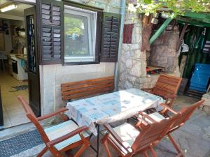 a table and chairs sitting outside of a building at House Markovina in Cres