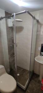 a bathroom with a shower with a toilet and a sink at Que chimba de apto. in Bogotá