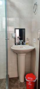 a bathroom with a white sink and a mirror at Que chimba de apto. in Bogotá