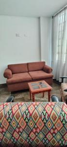 a living room with a couch and a coffee table at Que chimba de apto. in Bogotá