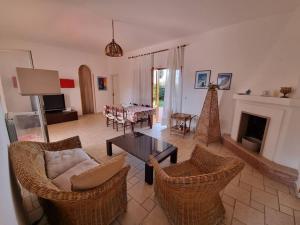a living room with a couch and chairs and a table at Villa Temistocle in Torre Santa Sabina