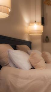 a bedroom with a bed with white pillows at Suite de Luxe Jacuzzi balnéo,King size Bed in Collobrières