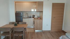 a kitchen and dining room with a table and chairs at Apartments Nikola Caska in Novalja