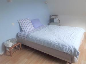 Ένα ή περισσότερα κρεβάτια σε δωμάτιο στο Dom & ses chambres d'hôtes