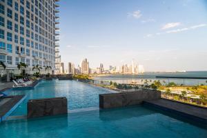 a swimming pool in the middle of a city with buildings at private ocean view studio apartment in Panama City