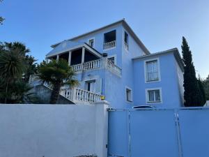 a white house behind a white fence at Casa Azzura in Bastia