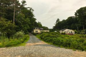 a gravel road with houses in the distance at Black Cove Cottage in Manchester