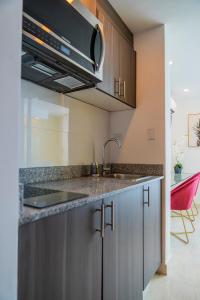 a kitchen with a sink and a counter top at private ocean view studio apartment in Panama City