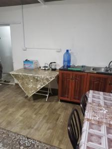 a kitchen with a table and some chairs and a counter at Studeo for rent in Amman