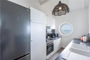 a kitchen with a large refrigerator and a sink at Only4View rooftop Sainte-Anne in Sainte-Anne